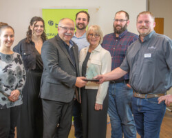 Creekridge Farms Ltd. Represented by Bill Prybylski and members of his family accepted the Ag Production Award from Tony Dales of Mazergroup.
