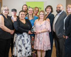 Jenna Niebergall of Suncrest College presented the Award of Excellence to the staff of Venvi The Bentley.