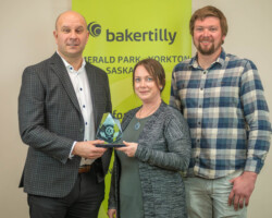 Ryan Kitchen of Baker Tilly presented the Large Business of the Year Award to Nicole Ardell and Dustin Balabuck of Potzus Paving and Road Maintenance Ltd.